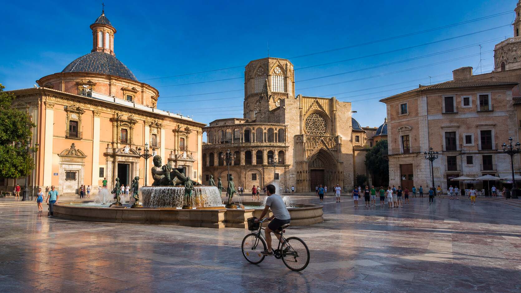 Plaça de la Mare de Déu in Valencia with cyclist and historic buildings